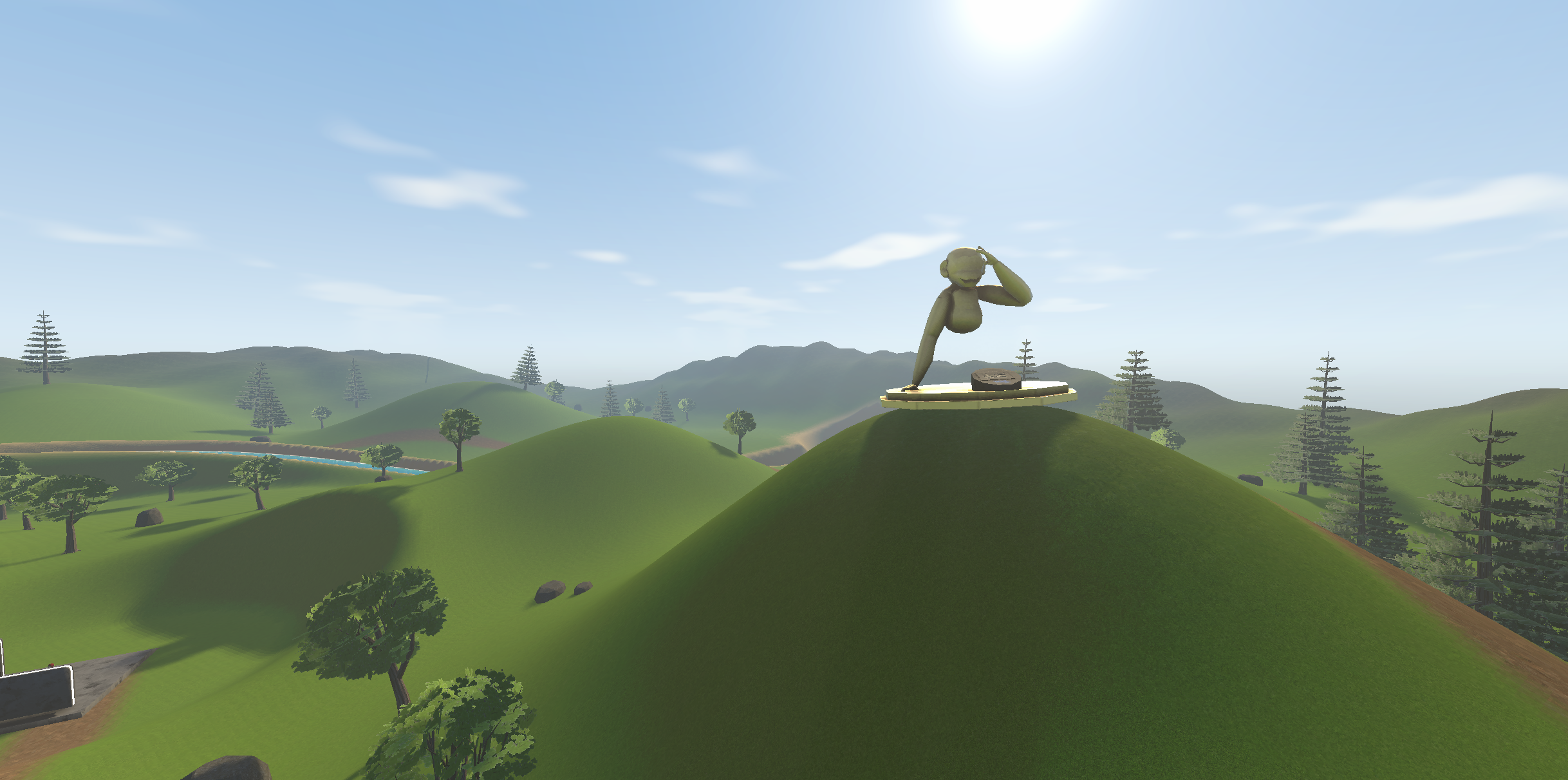 Forest in Gorillas Lab: a gorilla statue on a grassy hill surrounded by trees, with a river and rolling hills beneath a blue sky.